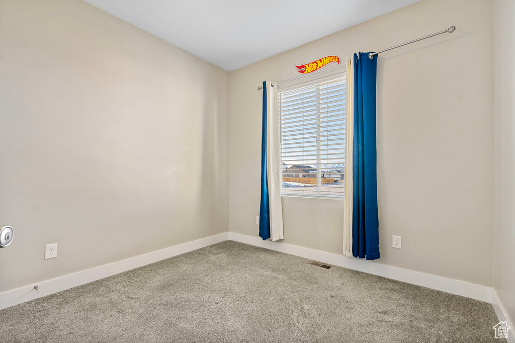 Spare room featuring carpet flooring