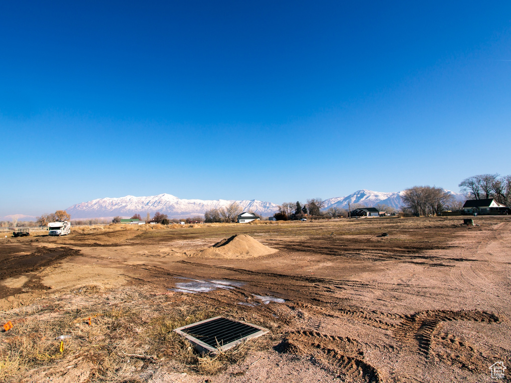 View of yard with a rural view and a mountain view
