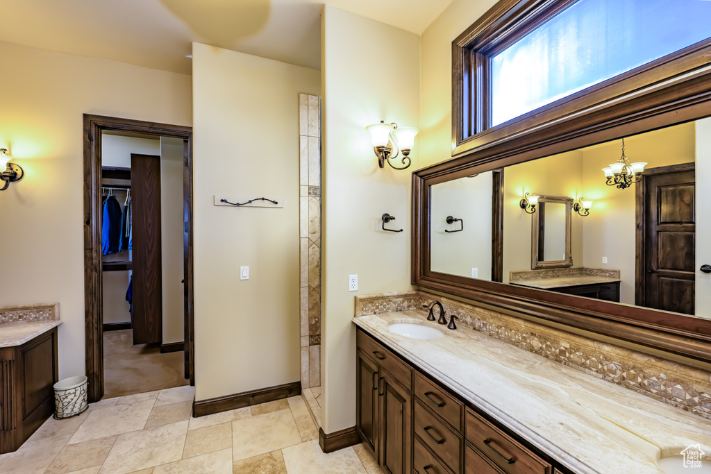 Bathroom with a chandelier and vanity