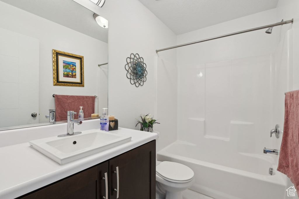 Full bathroom featuring washtub / shower combination, toilet, and vanity