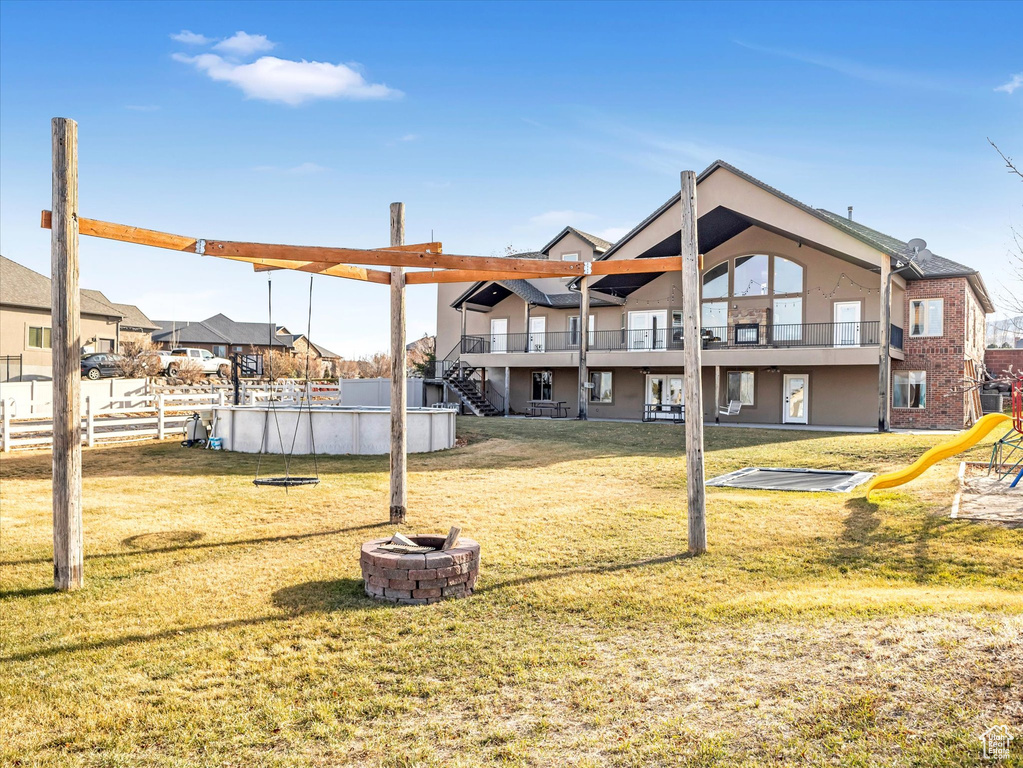 Exterior space featuring a yard and a fire pit