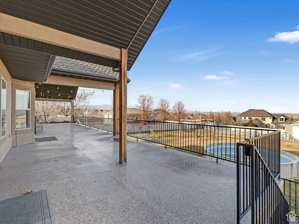 View of patio with a fenced in pool