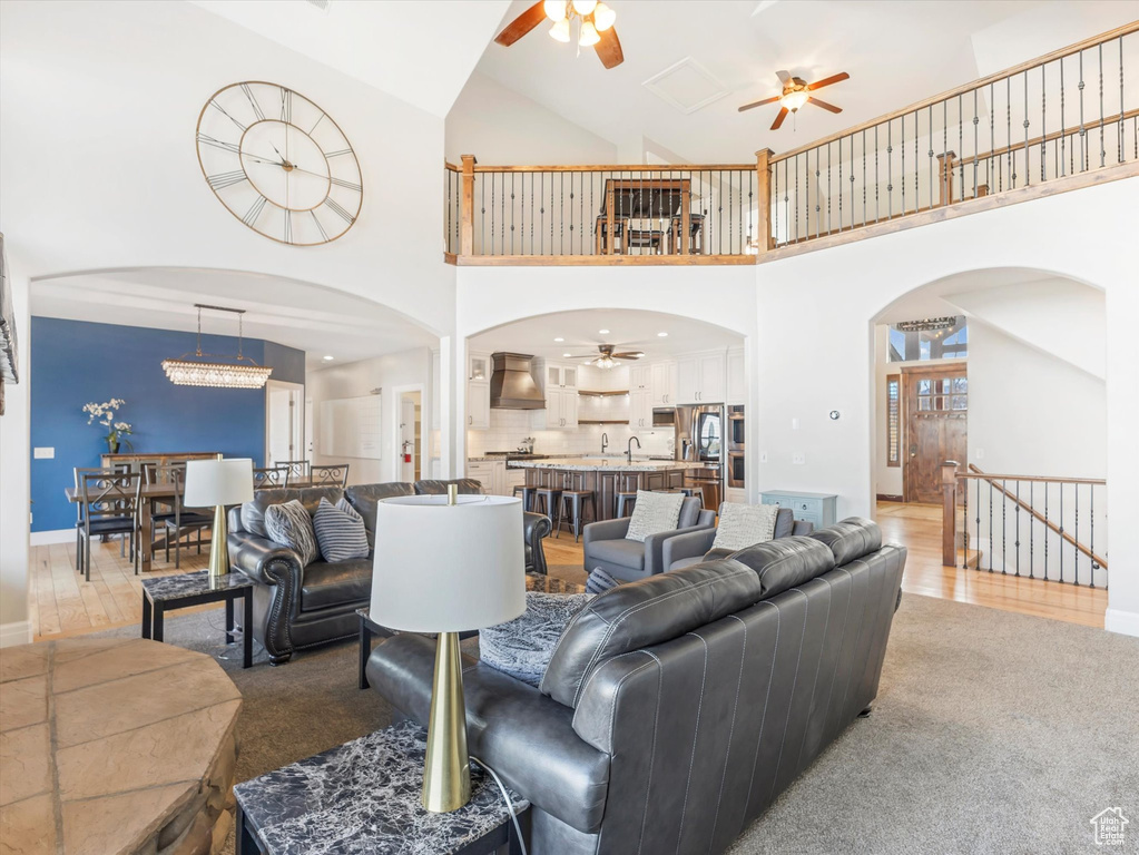 Carpeted living room with high vaulted ceiling
