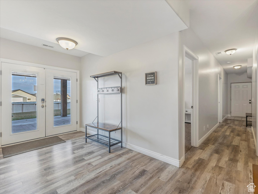 Interior space with french doors and wood-type flooring