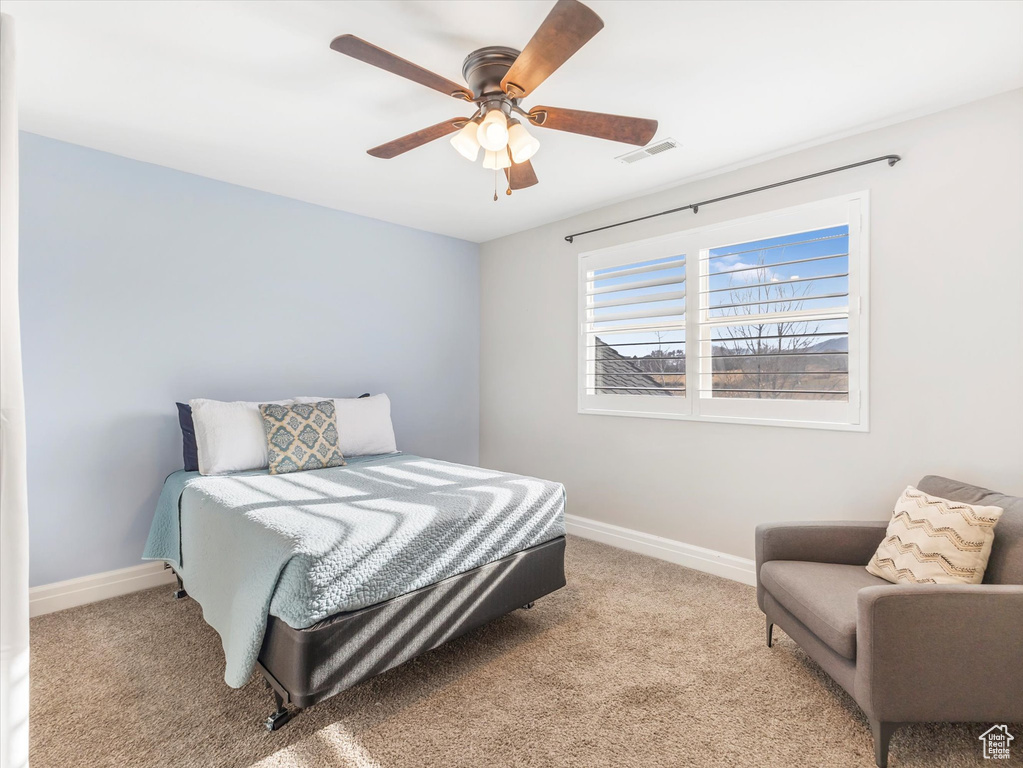 Bedroom featuring ceiling fan and light colored carpet