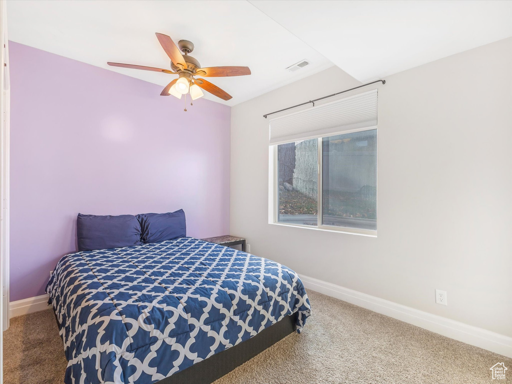 Carpeted bedroom with ceiling fan
