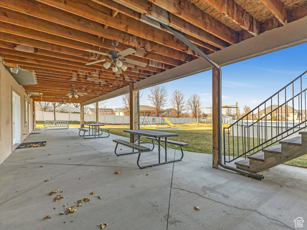 View of patio / terrace featuring a playground and ceiling fan