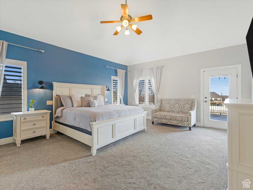 Carpeted bedroom featuring access to exterior and ceiling fan