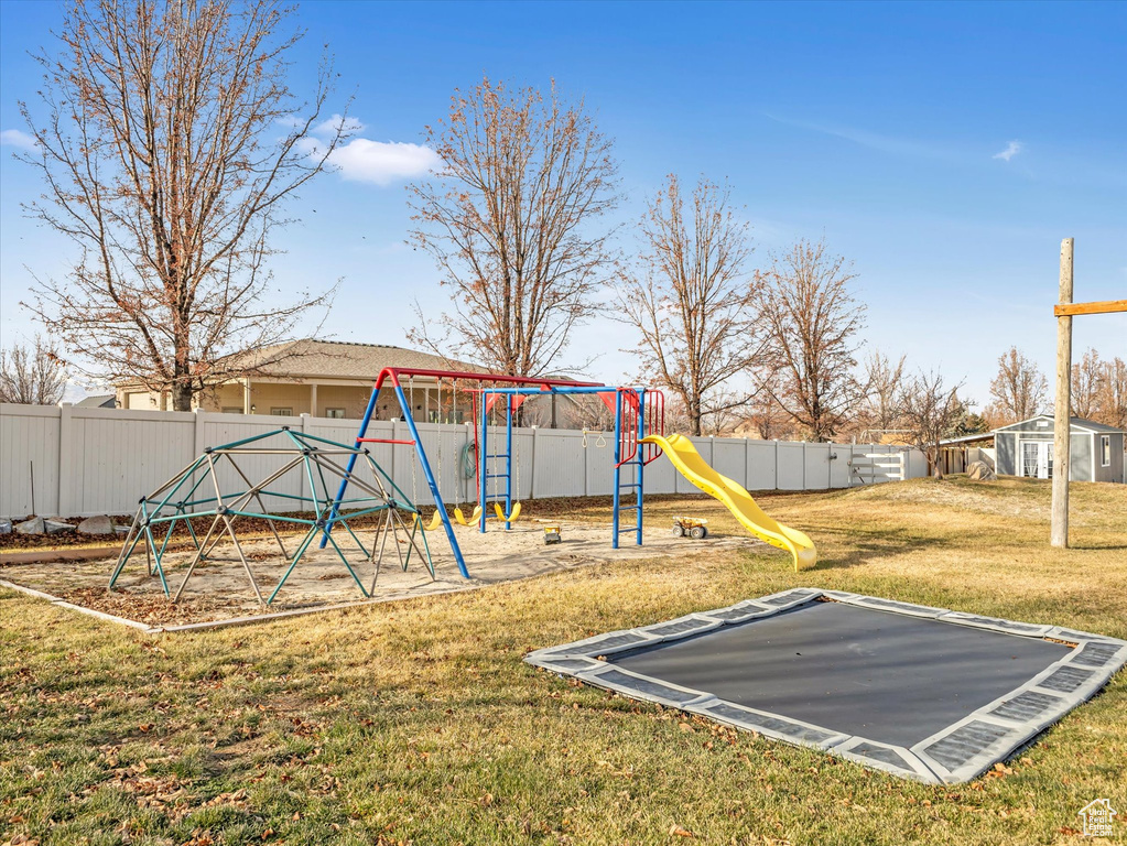 View of jungle gym featuring a lawn