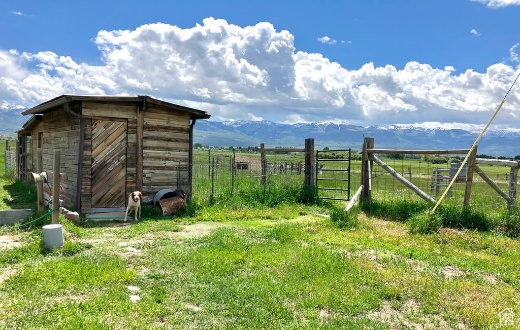 View of yard with a rural view, a mountain view, and a storage unit