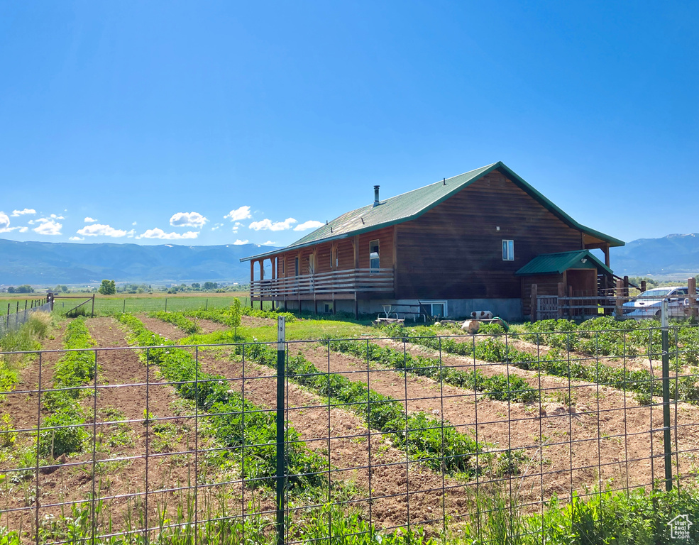 View of side of property with a mountain view and a rural view