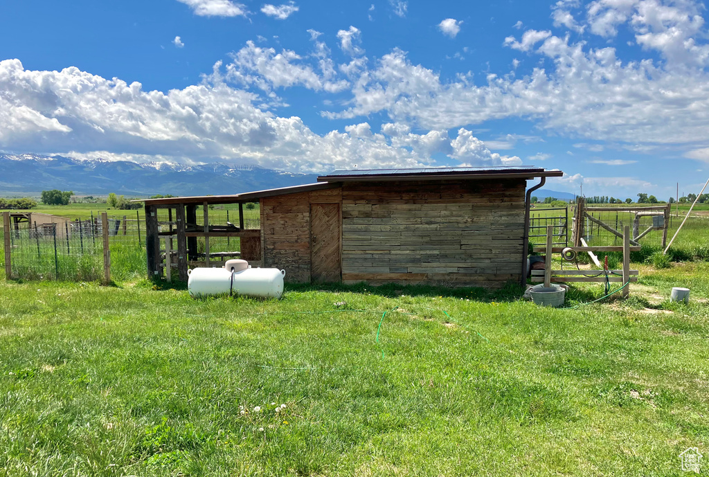 View of outdoor structure featuring a rural view and a yard