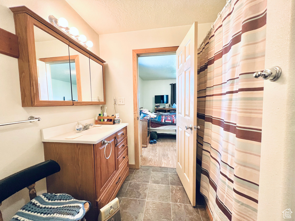 Bathroom featuring vanity and a textured ceiling