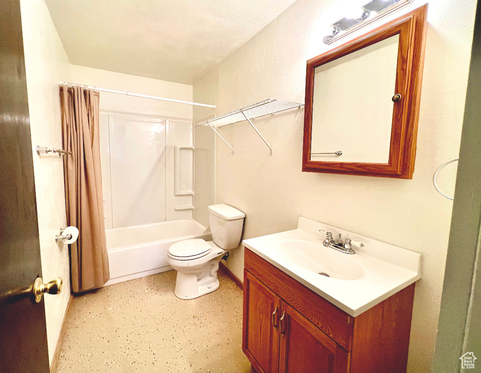 Full bathroom with shower / bath combo with shower curtain, toilet, and vanity