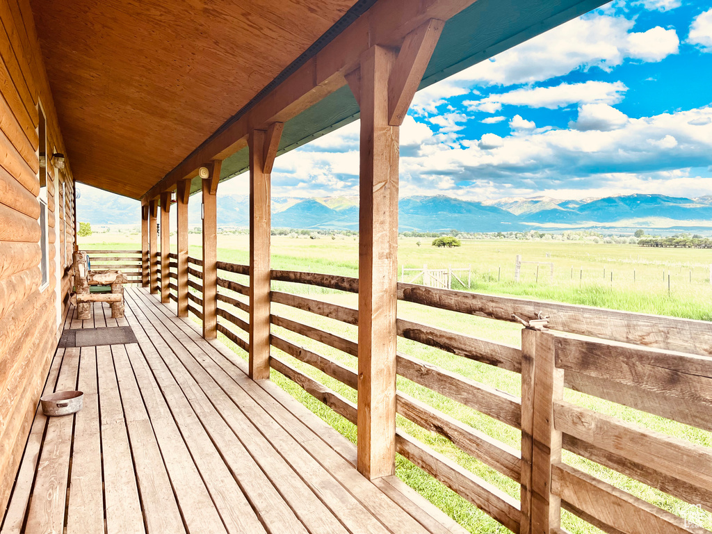 Wooden deck featuring a mountain view and a rural view