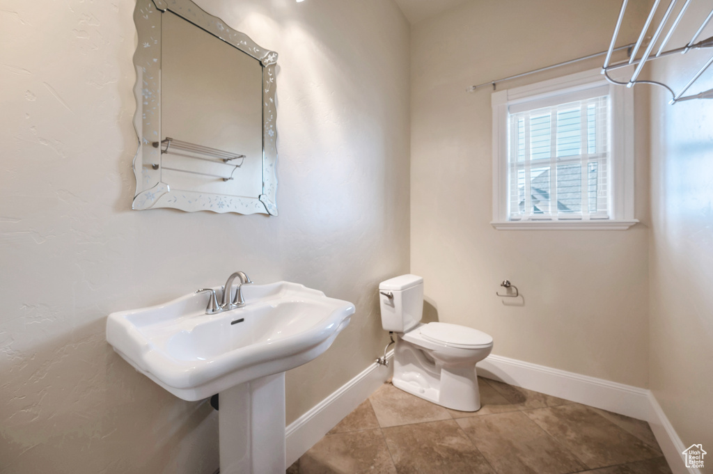 Bathroom featuring sink, tile patterned flooring, and toilet