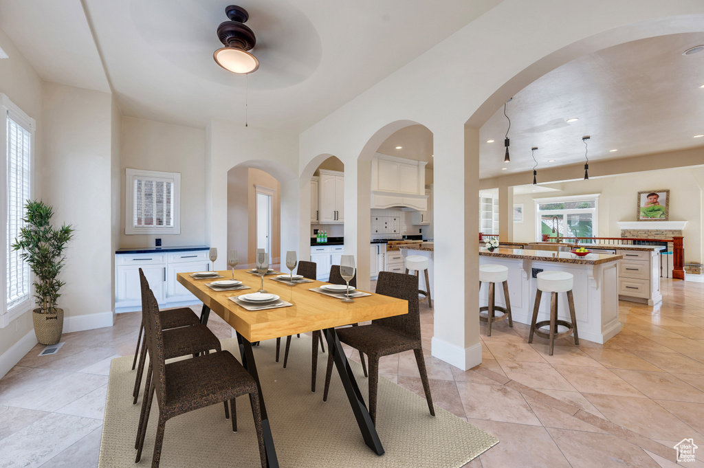 Tiled dining room with ceiling fan