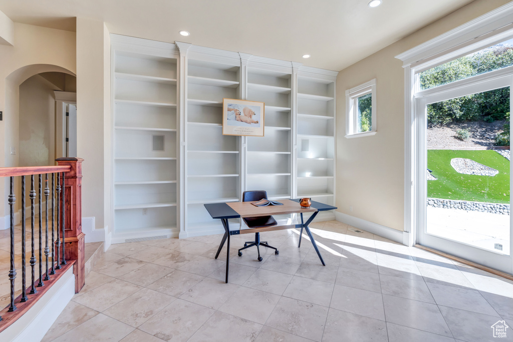 Office space with built in features and light tile patterned floors