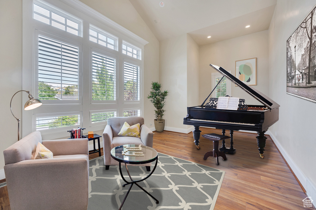 Sitting room featuring hardwood / wood-style flooring and high vaulted ceiling