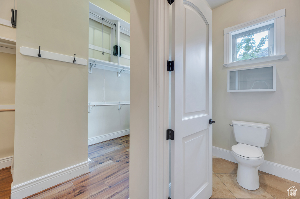 Bathroom with hardwood / wood-style floors and toilet