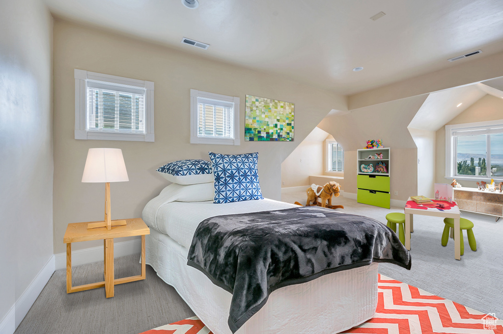 Bedroom featuring lofted ceiling and carpet floors