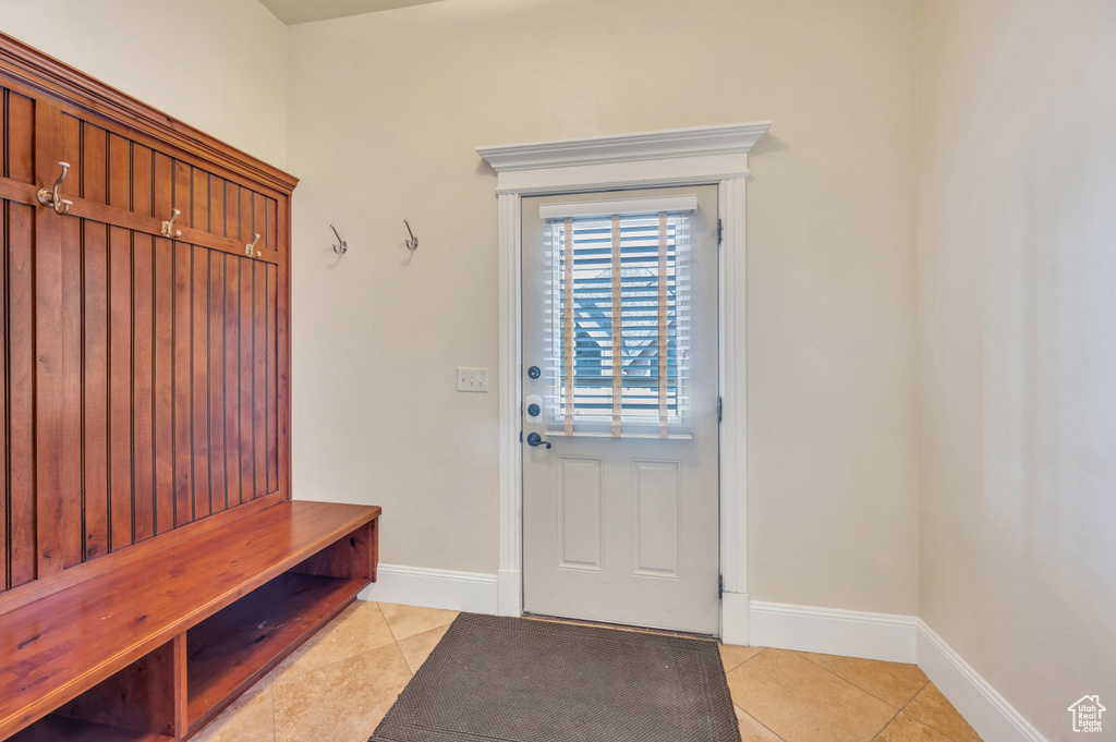 Mudroom with light tile patterned floors