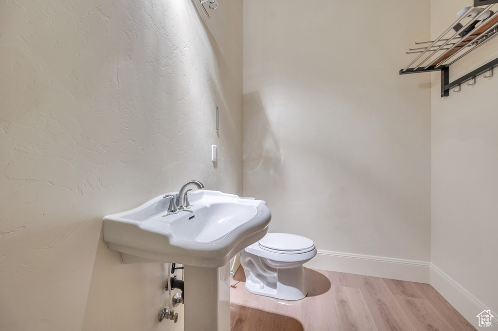 Bathroom with hardwood / wood-style floors and toilet