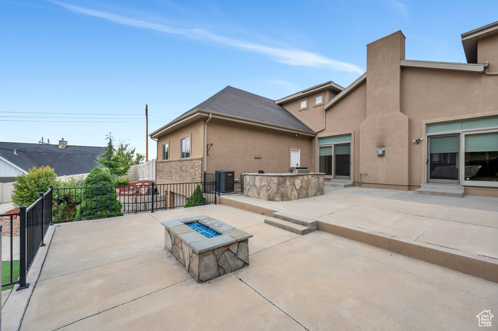 View of patio / terrace with a fire pit and central air condition unit