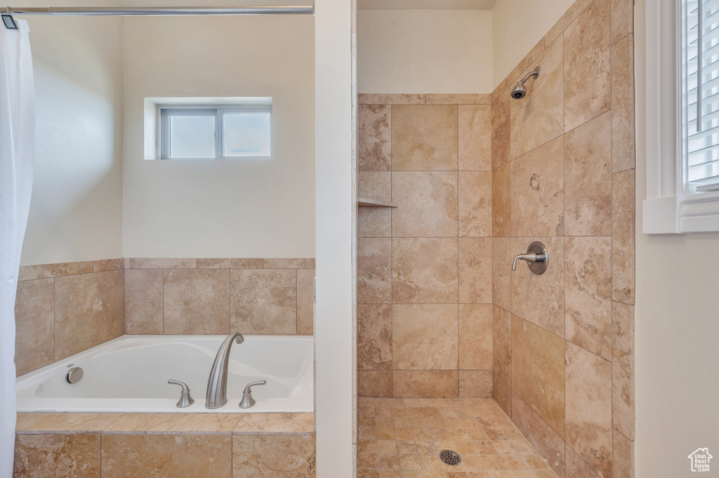 Bathroom with plenty of natural light and independent shower and bath