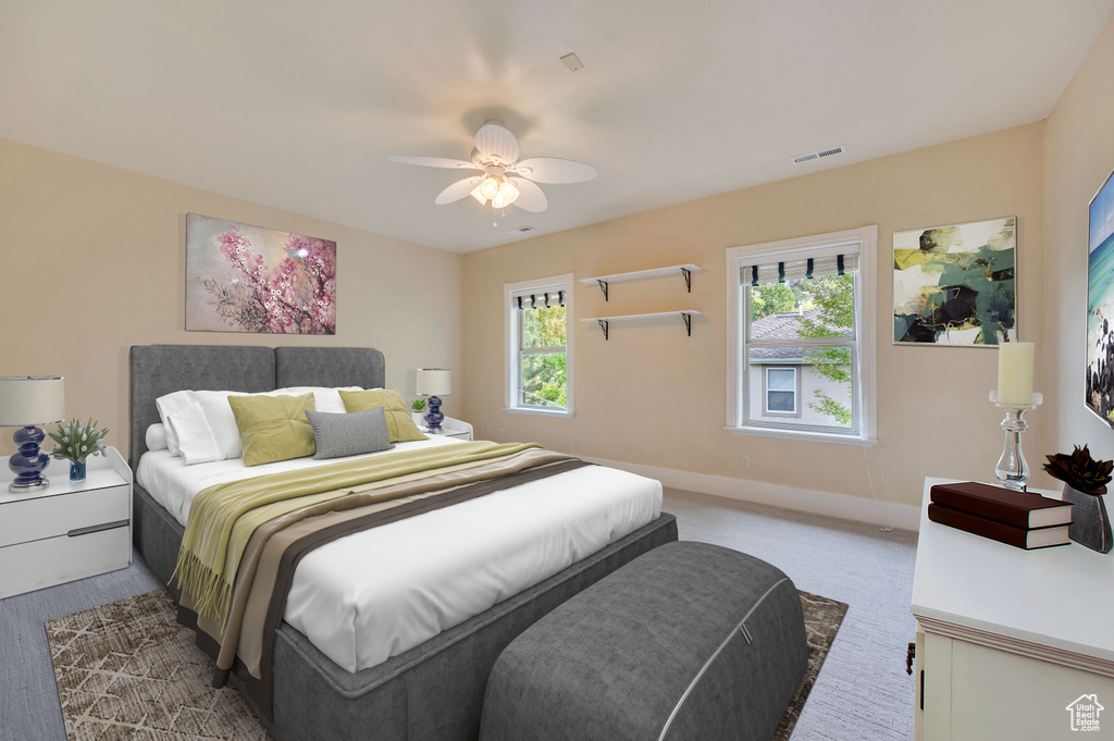 Bedroom with ceiling fan and multiple windows