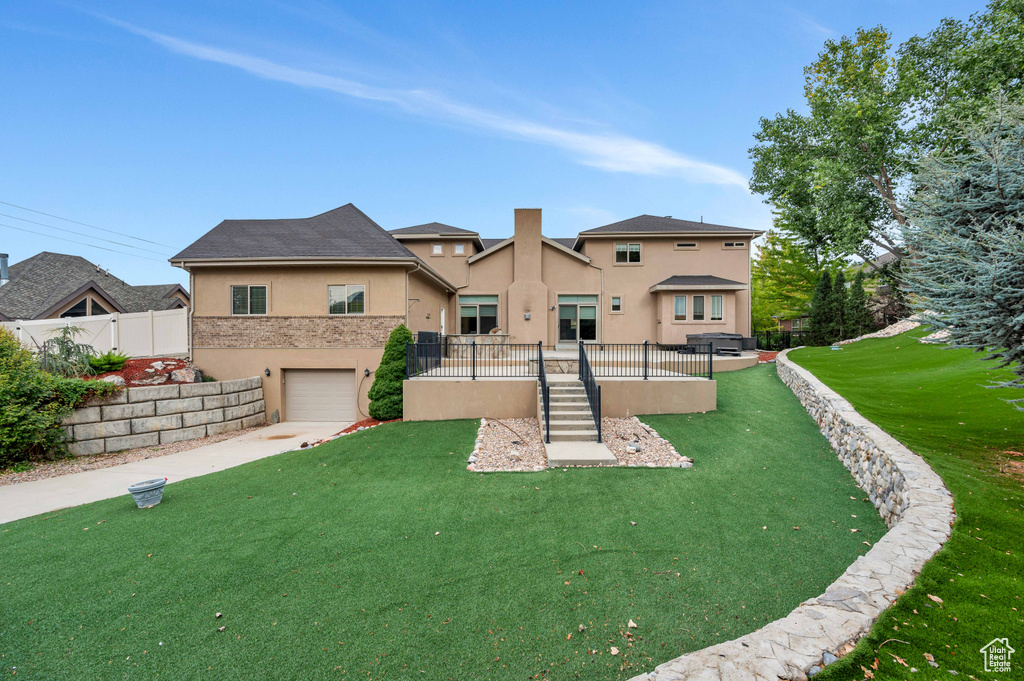 Back of property with a yard and a garage