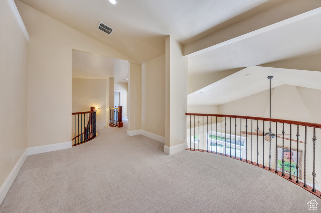 Corridor featuring carpet and lofted ceiling