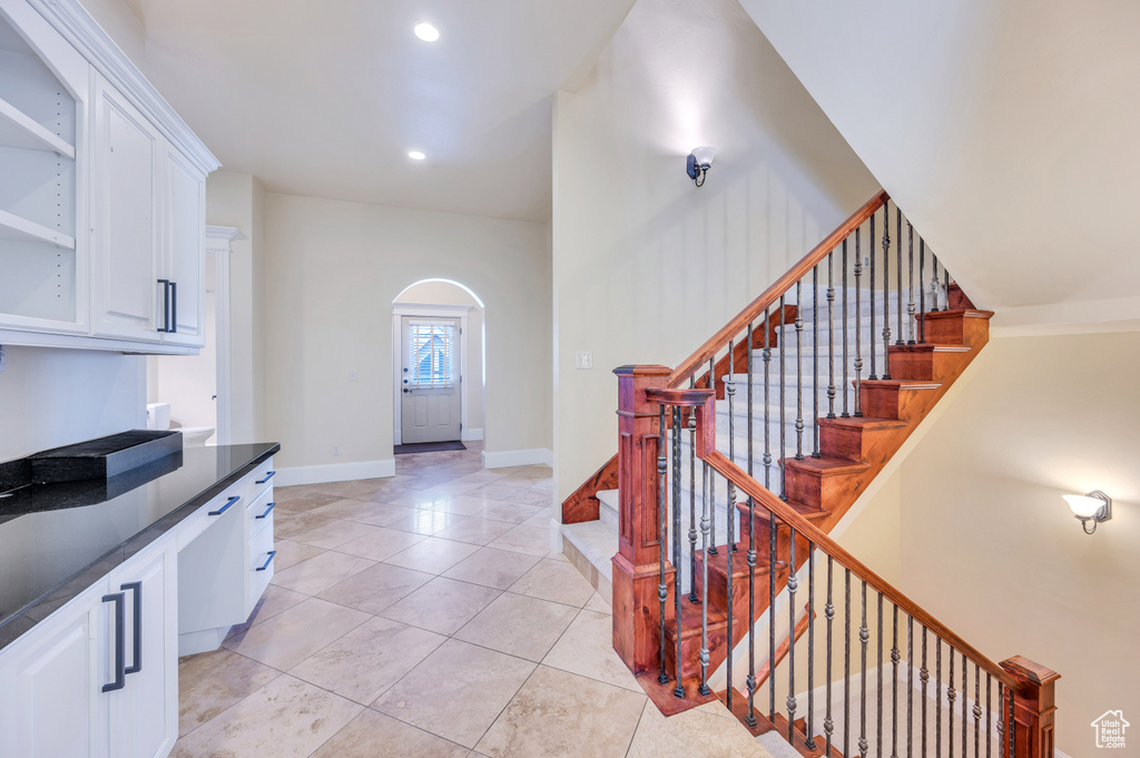 Kitchen featuring white cabinetry and light tile patterned flooring