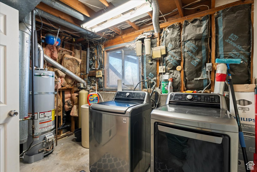 Washroom with washer and clothes dryer, water heater, and gas water heater