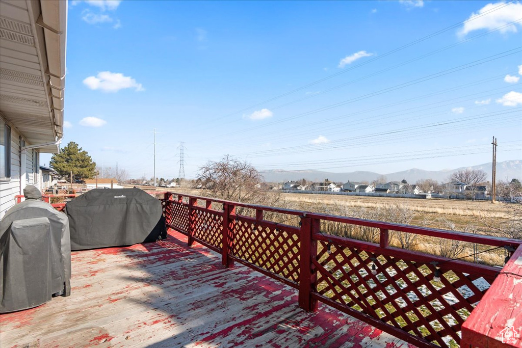 Wooden deck with grilling area and a mountain view