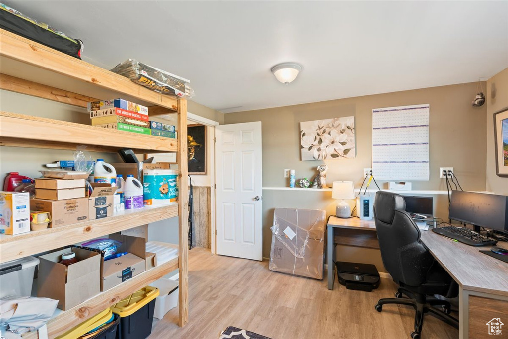 Home office with light hardwood / wood-style floors