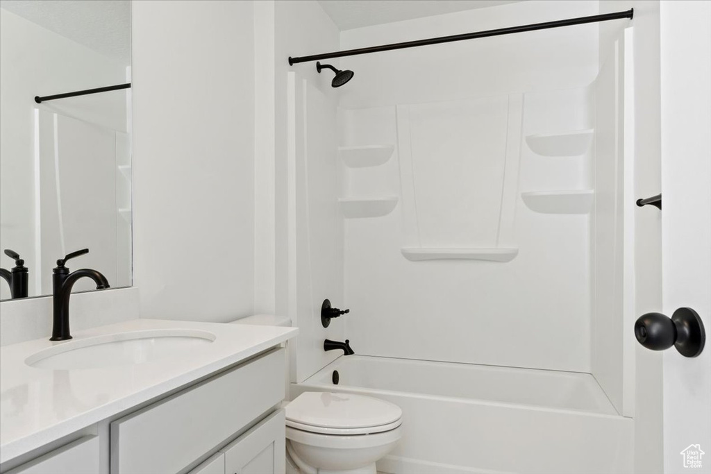Full bathroom featuring bathtub / shower combination, toilet, and vanity