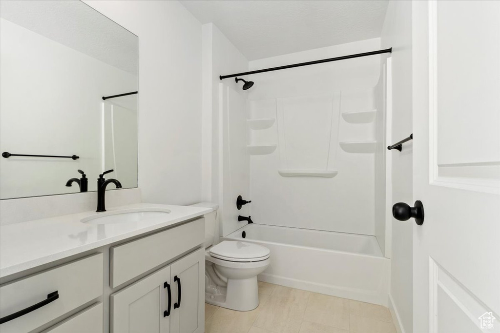Full bathroom with toilet, vanity, and bathing tub / shower combination