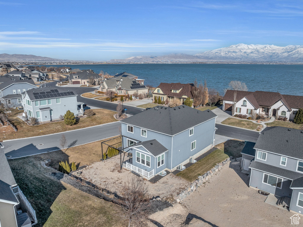 Birds eye view of property featuring a water and mountain view