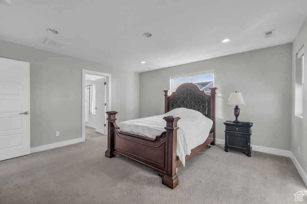 Bedroom featuring light carpet