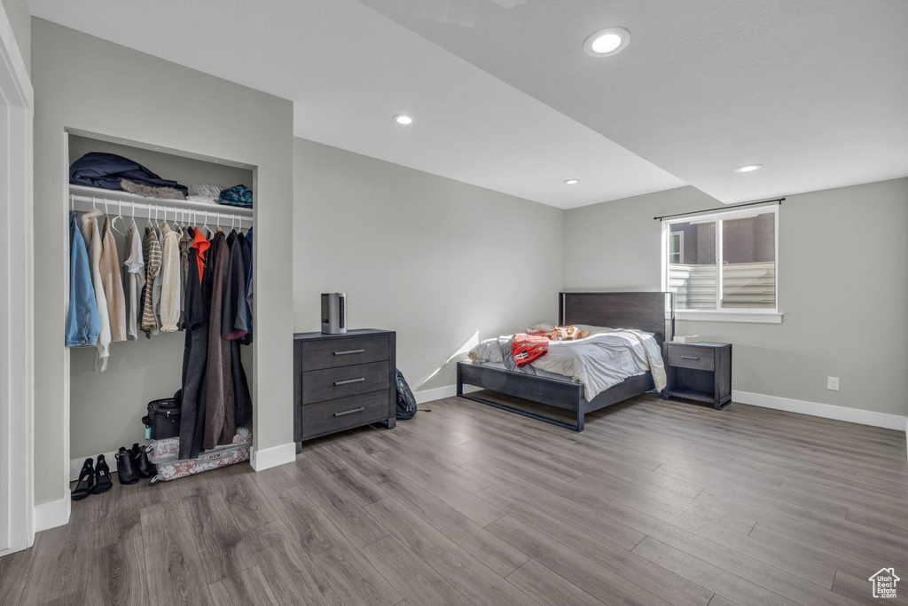 Bedroom with light wood-type flooring and a closet