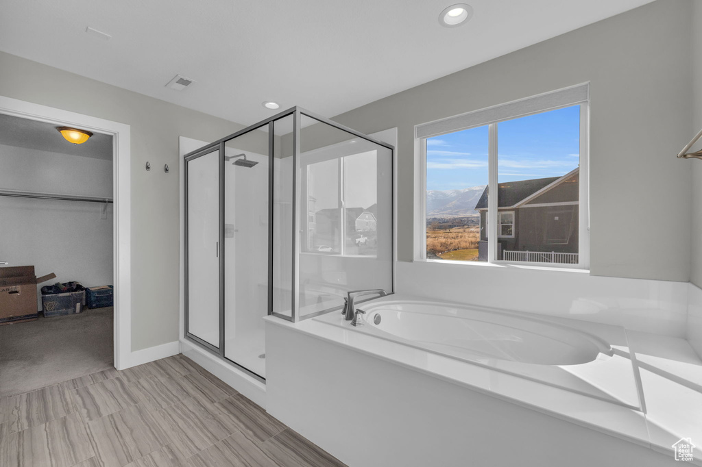 Bathroom featuring shower with separate bathtub