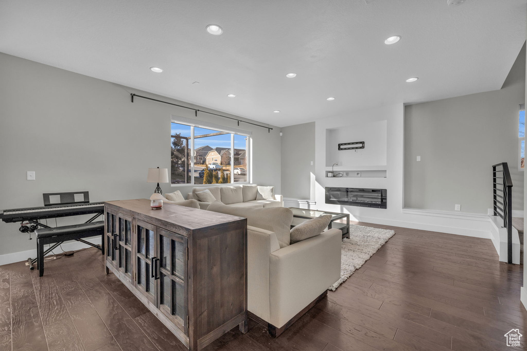 Living room with dark wood-type flooring