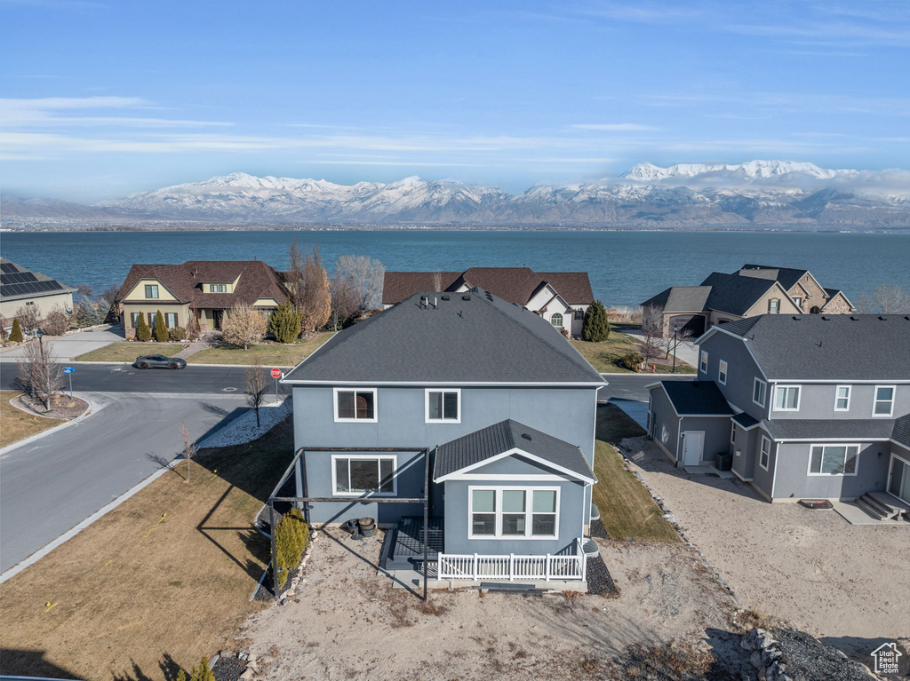 Back of house with a water and mountain view