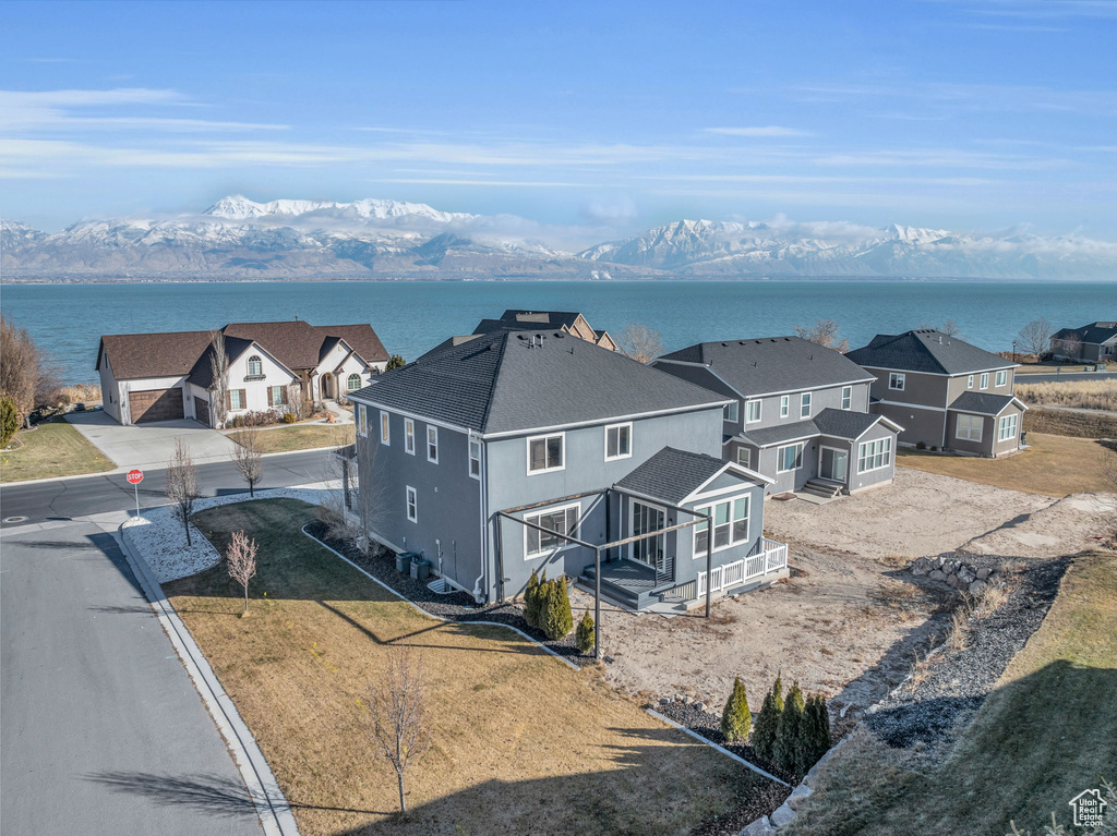 Birds eye view of property with a water and mountain view