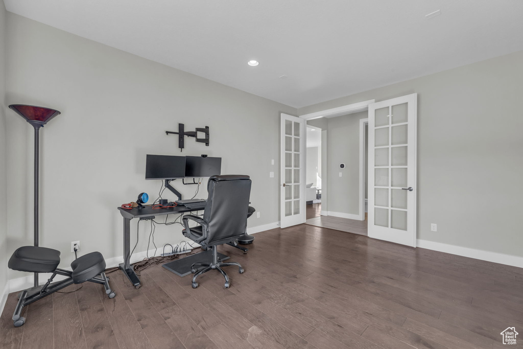 Office space with hardwood / wood-style floors and french doors