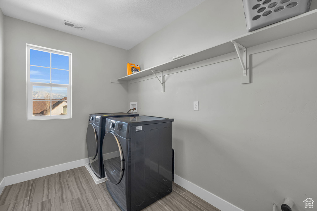 Laundry area featuring washing machine and clothes dryer