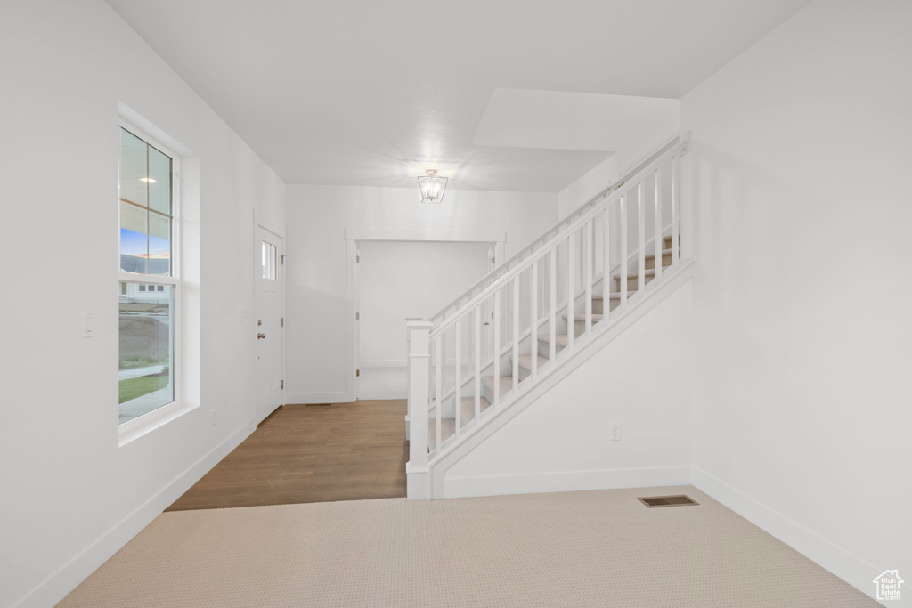 Entryway with stairway and baseboards