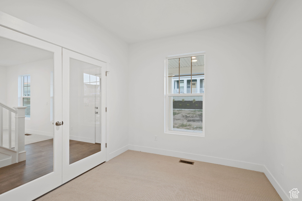 Empty room with stairs and carpet flooring
