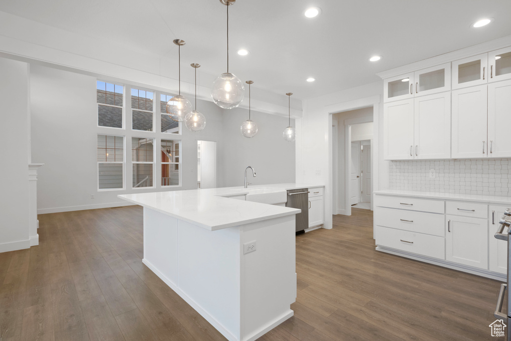 Kitchen with dishwasher, tasteful backsplash, glass insert cabinets, white cabinetry, and recessed lighting